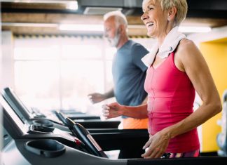 Senior man and woman exercising on treadmills
